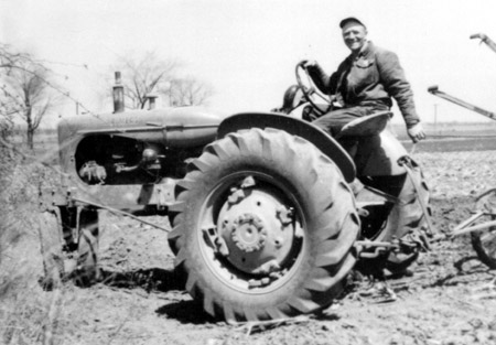 Roger on a tractor with a large smile.